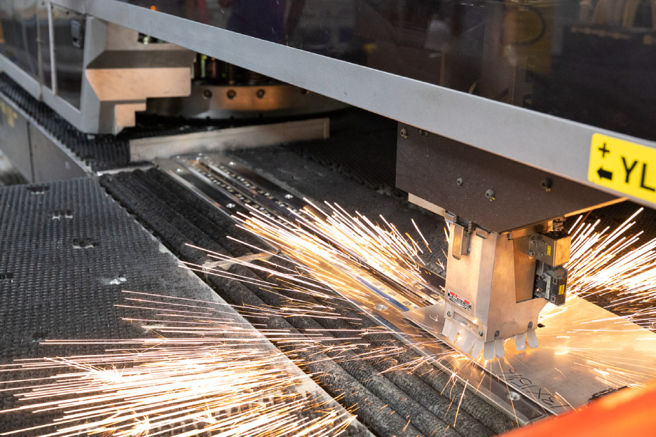 Sparks fly inside Amada's laser-cutting machines shot by Dan Bigelow