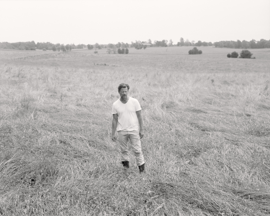 Film portrait of Steve Zahn in a grassy field shot by Egan Parks for the Hollywood Reporter