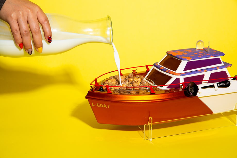 Milk being poured into the little yatch's milkcuzzi. Photographed by Emily Malan for Reese's Puffs. 