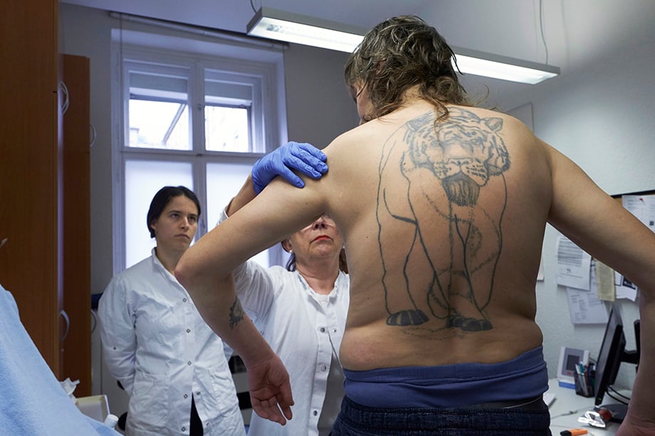 A man being examined by medical staff. Photographed by Enno Kapitza