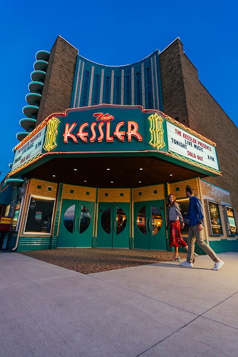A couple walks towards The Kessler Theatre. Photography by Inti St. Clair for Visit Dallas. 
