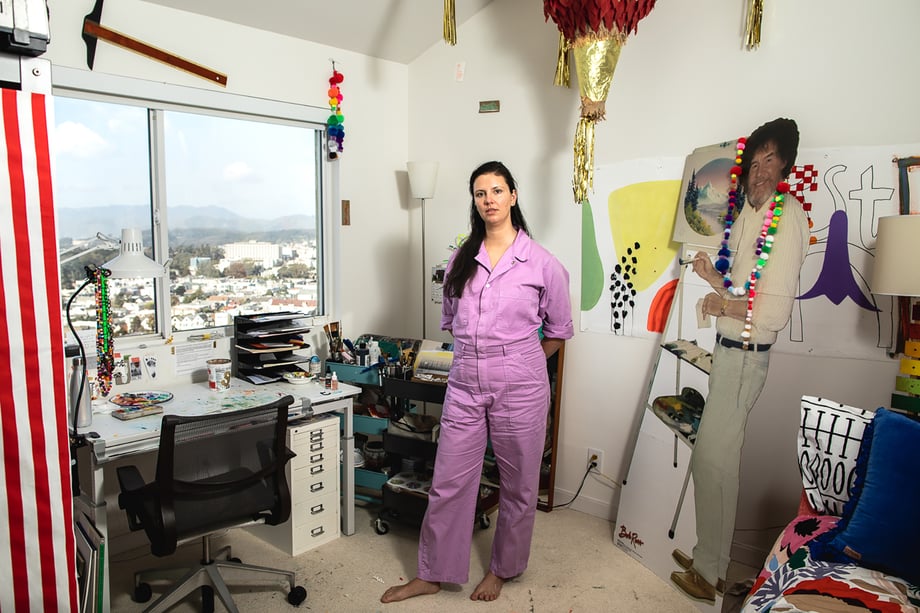 Woman in her quirky studio with a pom-pom wearing cut out of Bob Ross shot by Jaime Borschuk for Women at Home project