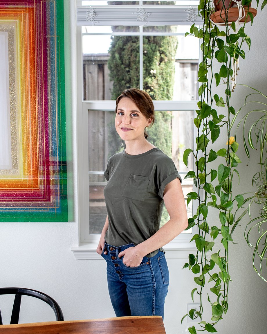 Woman standing by hanging plant and rainbow glass art shot by Jaime Borschuk for Women at Home project
