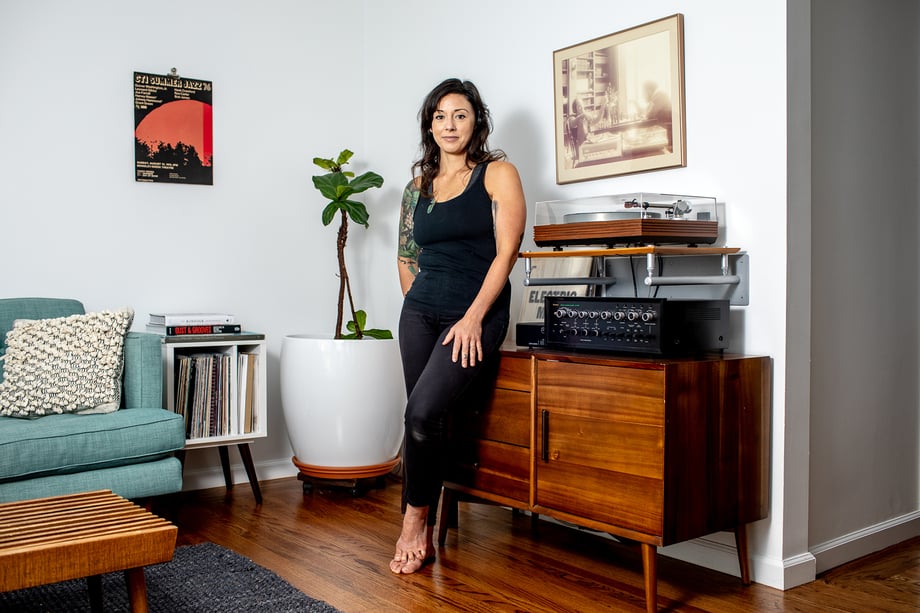 Woman leaning next to her record player shot by Jaime Borschuk for Women at Home project 