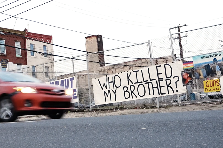 A sign that reads "Who Killed My Brother" hangs in Kensington during Operation Save Our City's camp out. Photo by Joe Quint. 