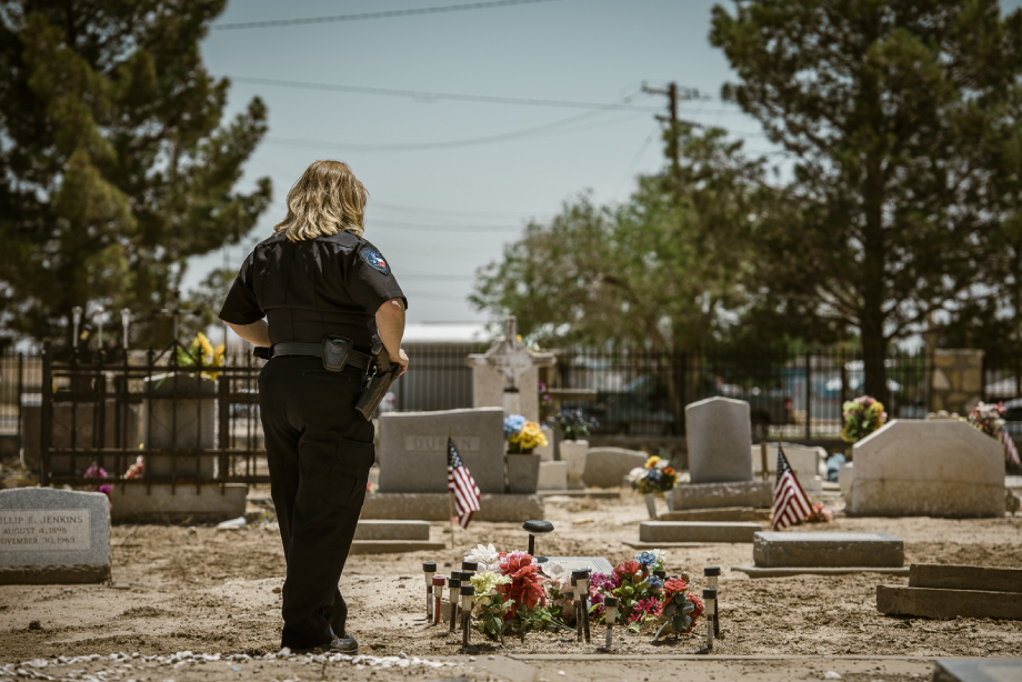 Chief of Pecos police Lisa Tarango viewing Pecos Jane's tombstone shot by John Davidson for Texas Monthly