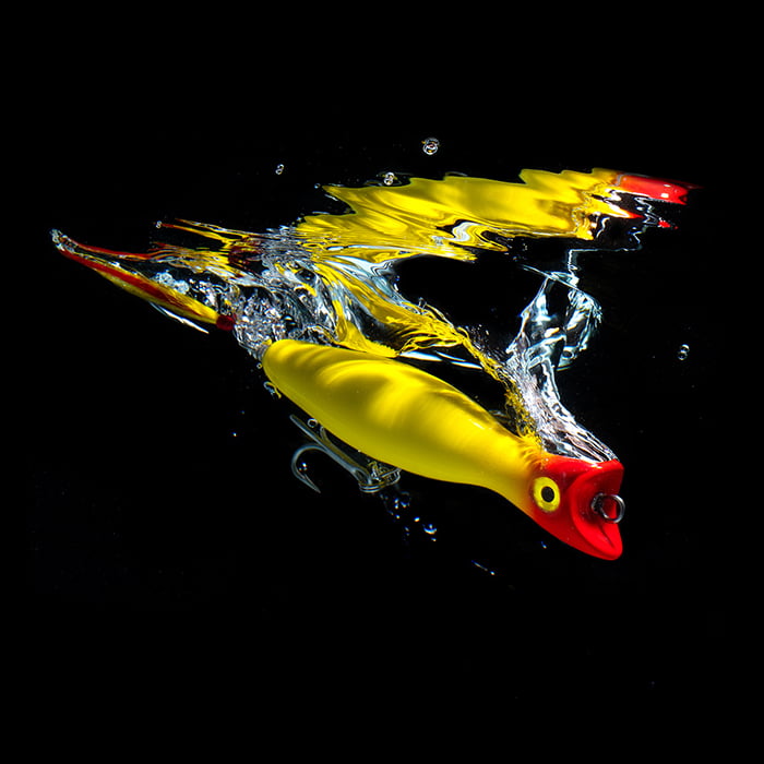 A bright yellow and red fishing lure photographed by John Kuczala.