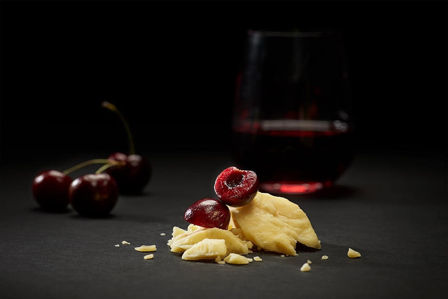 A close up of cheese pairing with cherries. Photographed by John Valls for Tillamook Creamery.