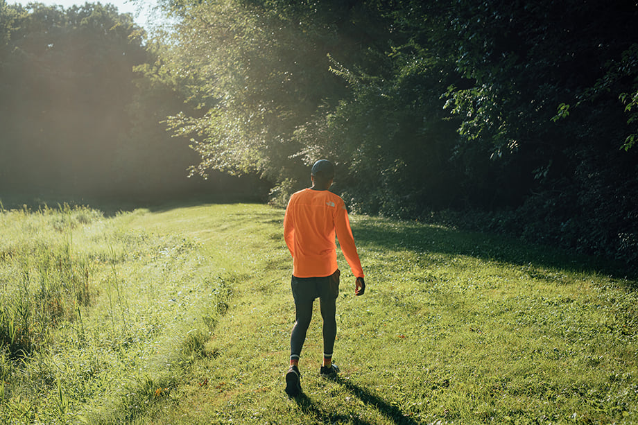 Coree Woltering walks through a lush green trail. Taken by Kevin Serna