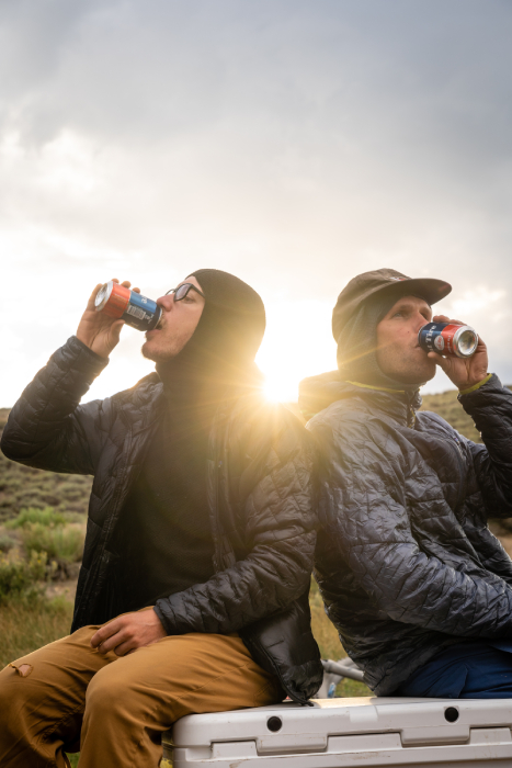 Behind the scenes shot of two men drinking Fat Tire from Kody Kohlman's film C-Team
