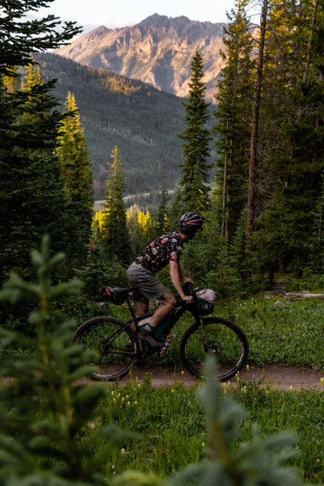 One biker looks left as he passes a mountain ridge from Kody Kohlman's film C-Team shot for Fat Tire