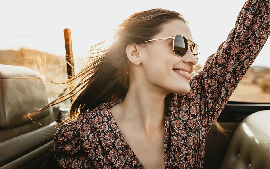 A model wearing American Optical's sunglasses while projecting a fun, care-free attitude. Photographed by Marissa Roseillier for American Optical. 