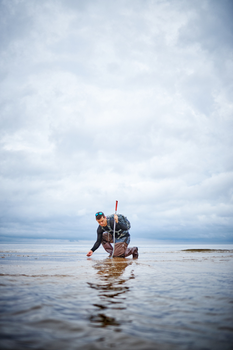 Fossil Hunter on the shore. Photographed by Matthew Rakola. 