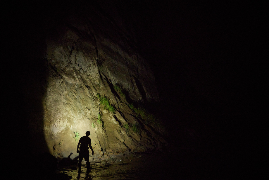 Fossil hunter searching at night with a headlamp. 