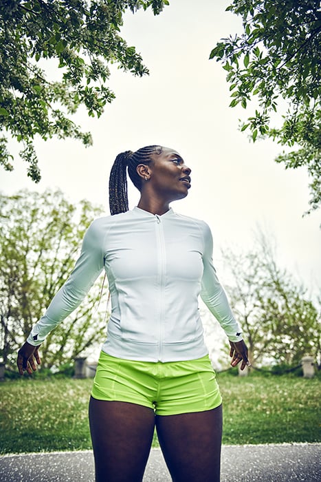 Aaliyah Covington, a local athlete, stretches in the park. Photographed by Max Thomsen for Milwaukee Magazine.