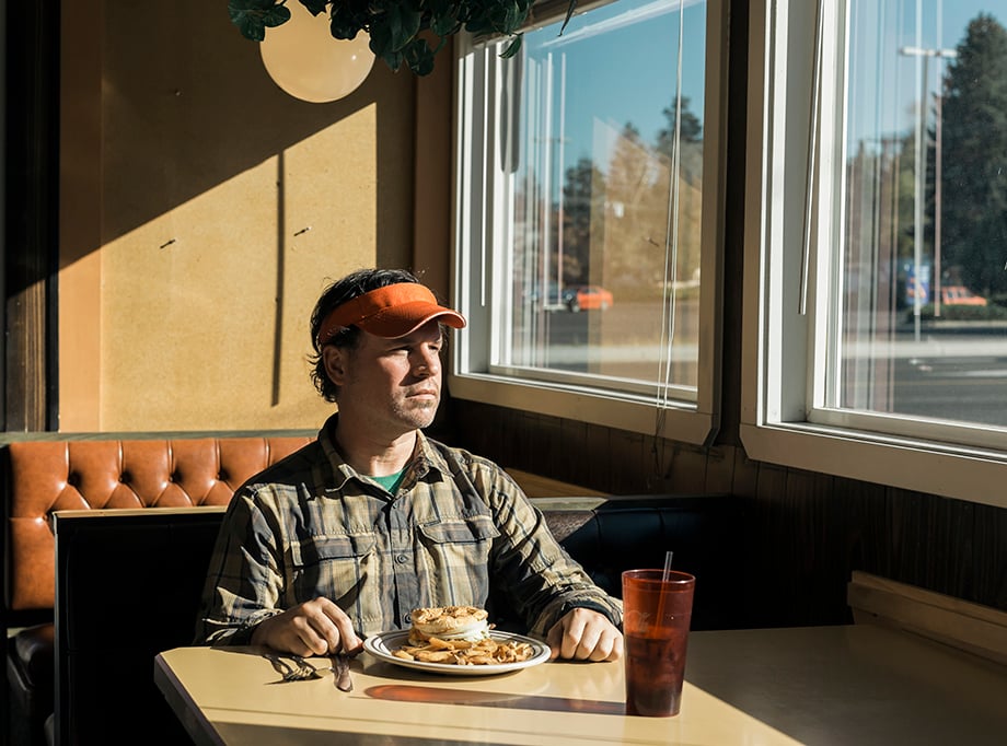 Rue McKenrick in a diner in Bend, Oregon. Photographed by Michael Hanson for Backpacker Magazine.