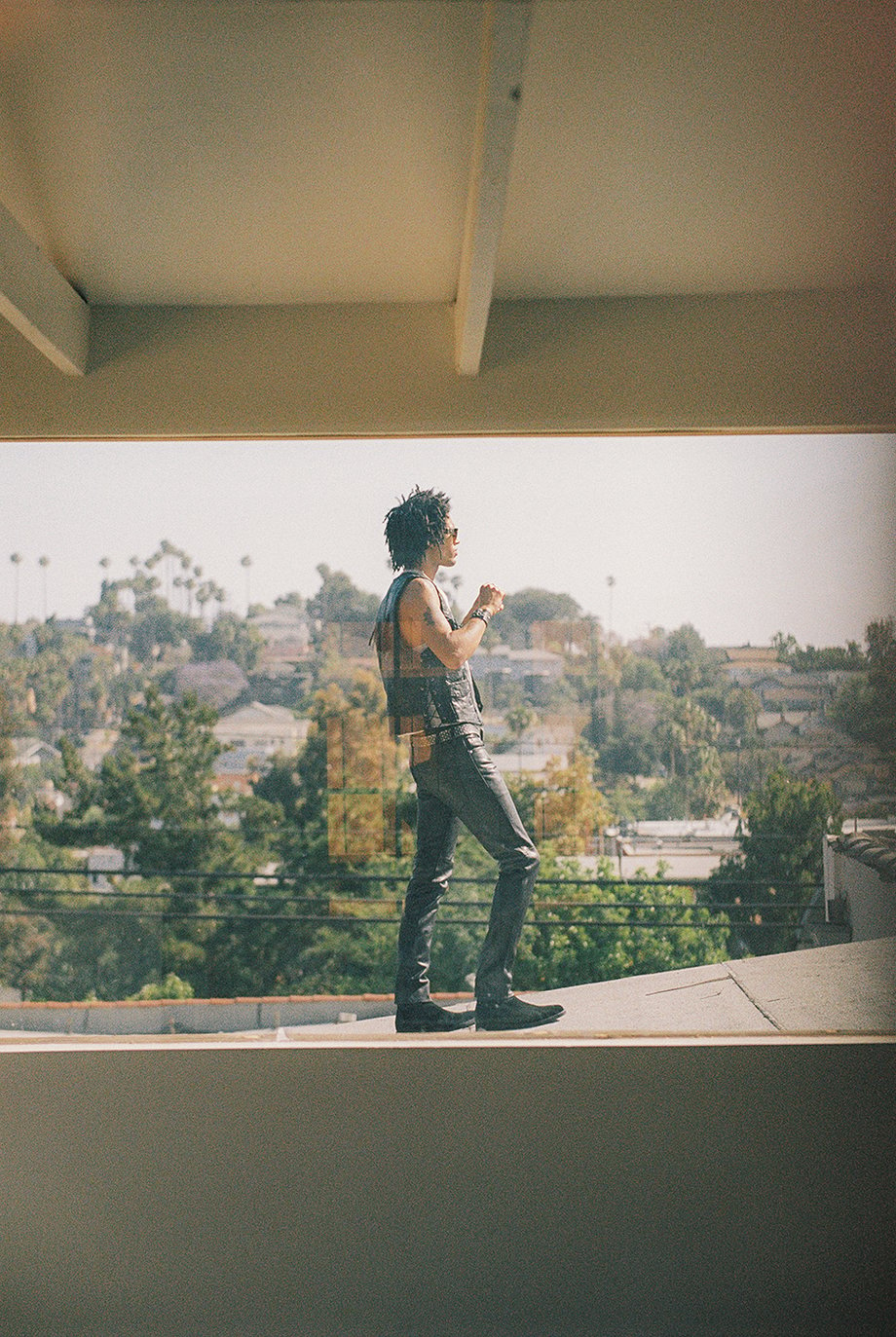 Model on roof shot from inside house by Michael Julius for New Republic footwear Sonoma campaign