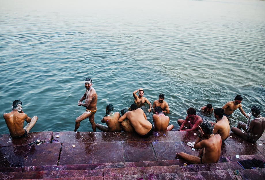 A group of men rinse off the dyes of Holi festival in the Ganges shot by Michael Marquand for Lodestars Anthology