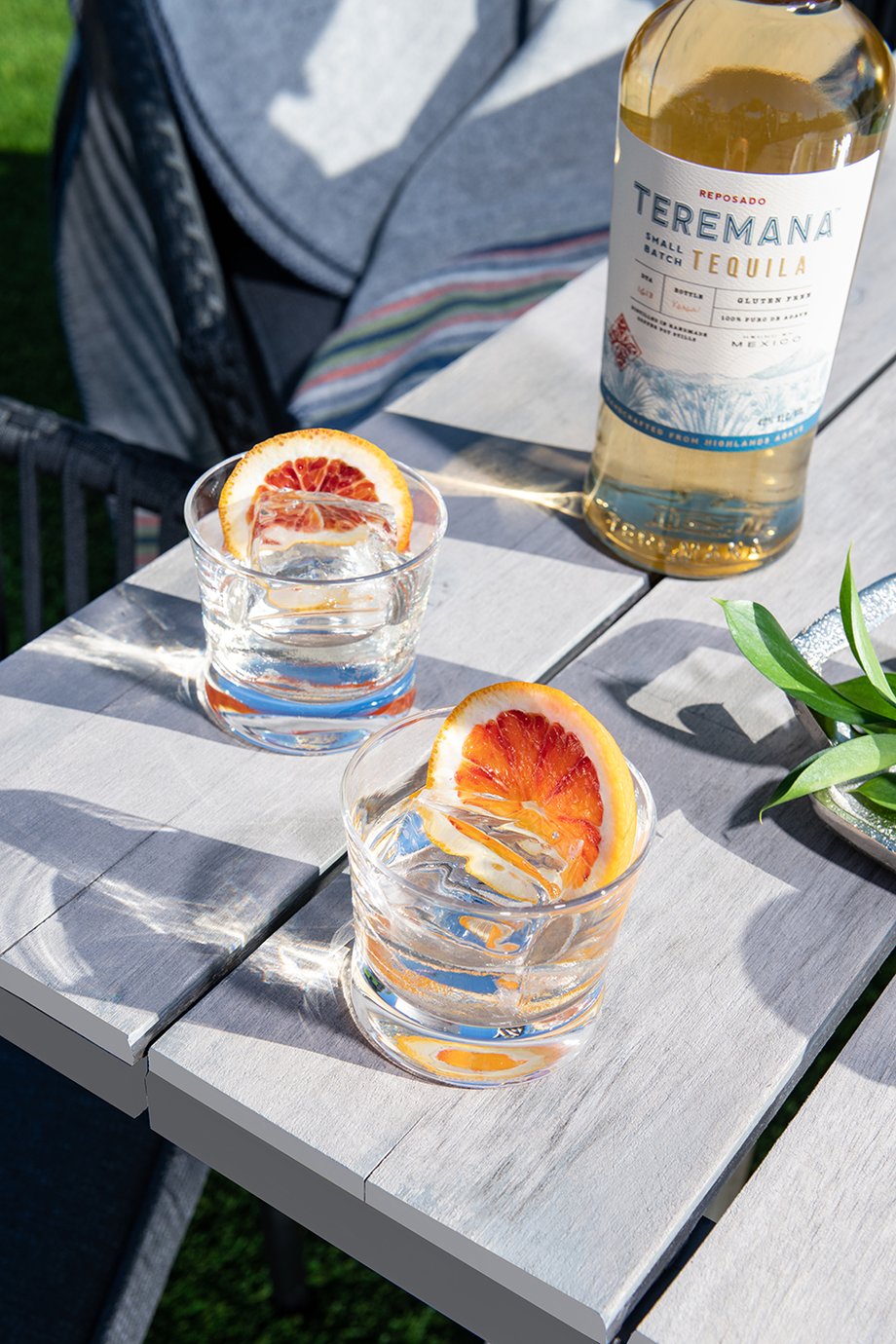 Two glasses filled with Teramana tequila and orange slices shot by Morgan Ione