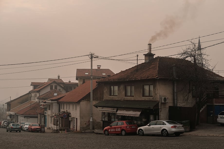 Smoke billows from the chimney of a bakery during a heavily polluted day in Sarajevo. Widespread burning of wood, poor quality coal, tires, plastic and rubbish contribute to periods of poor air quality during the winter.Photography by Nick St. Oegger. 