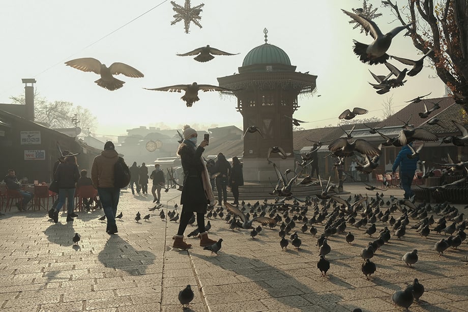 A woman takes photos in Sarajevo’s iconic “Pigeon Square” on a day when the city was one of the most polluted in the world, with an Air Quality Index (AQI) rating of 350. During the winter, Sarajevo often reaches the position of world’s most polluted city, outranking usual placeholders like New Delhi, Kolkata, Beijing and Dhaka.Photography by Nick St. Oegger. 