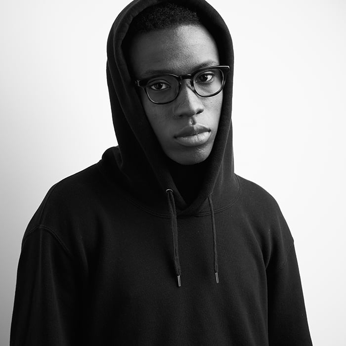 Richard Schmon photographs a black and white portrait of a male model wearing kits eyewear. 