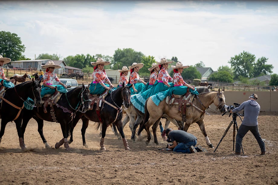Flor de Aguileña, a Mexican Escaramuza Charra team based in Denver rides horses during filming. Photography by Sean F. Boggs. 