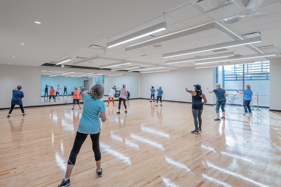 An aerobics class at Lewisville Thrive Recreation Center photographed by Wade Griffith for Barker Rinker Seacat Architecture.