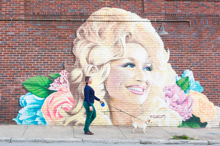 Cameron Reynolds photographs a Dolly Parton mural on the streets of West Asheville.