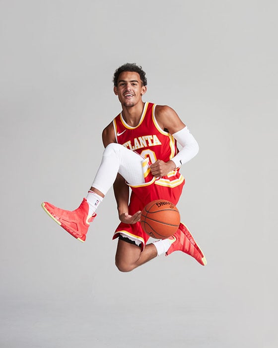 Trae Young mid air with basketball by Atlanta sports photographer Gregory Miller
