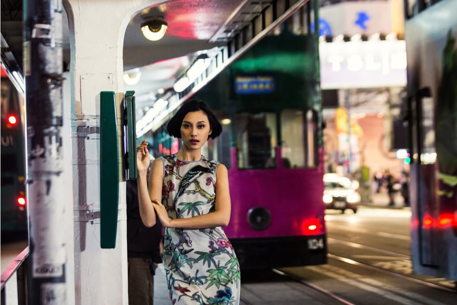 Fashionable woman poses near street tram by Gareth Brown, Hong Kong, China. 