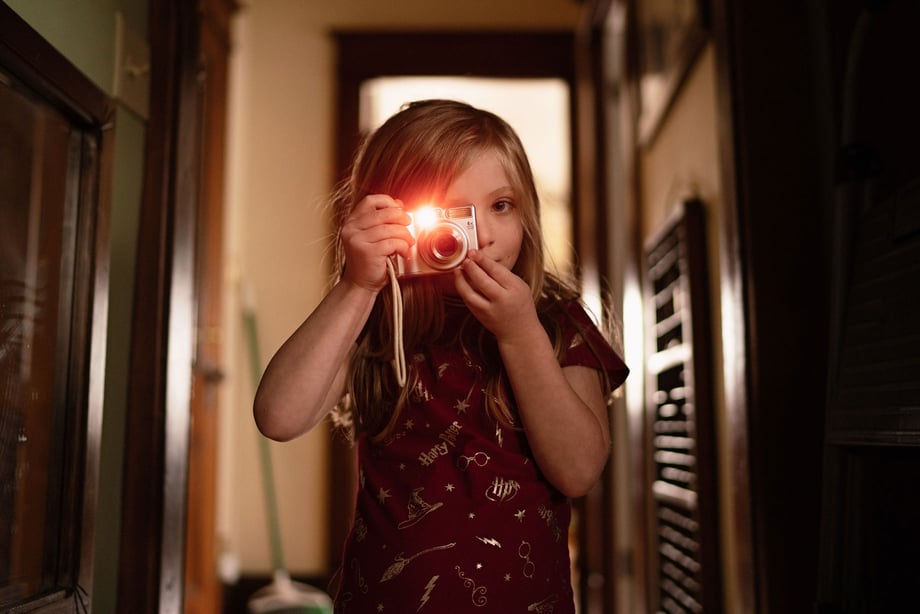 Photo of child with camera shot by Kat Schleicher