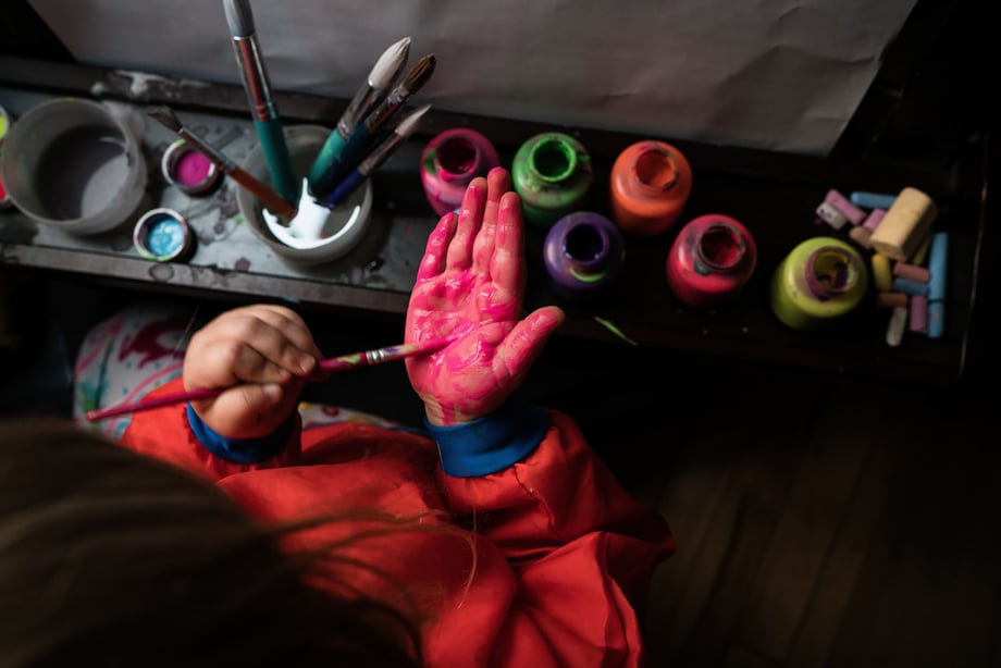 Photo of child painting shot by Kat Schleicher