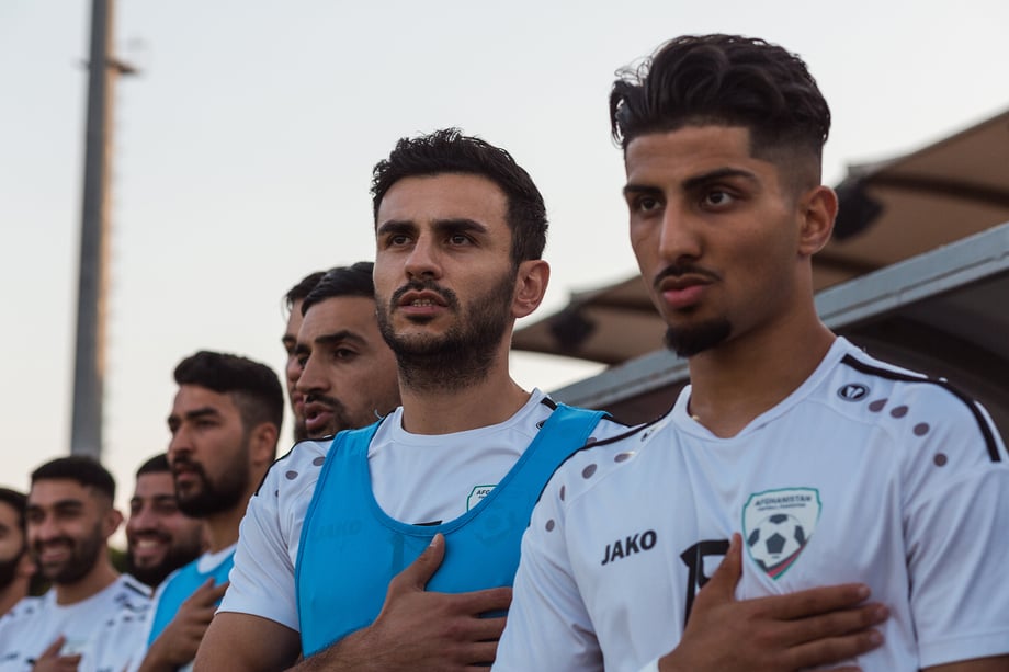 Part of the Afghan national soccer squad during the Afghan national anthem and raising of the Afghan flag, before the international friendly match against Indonesia. Shot by Bradley Secker for the New York Times