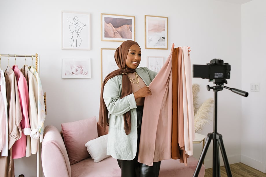 Aysha Harun in front of the camera shooting a YouTube video.