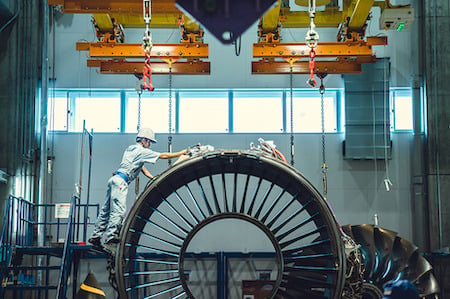 Man cleans the outside of an airplane engine shot by Tokyo-based automotive and industrial photographer Irwin Wong