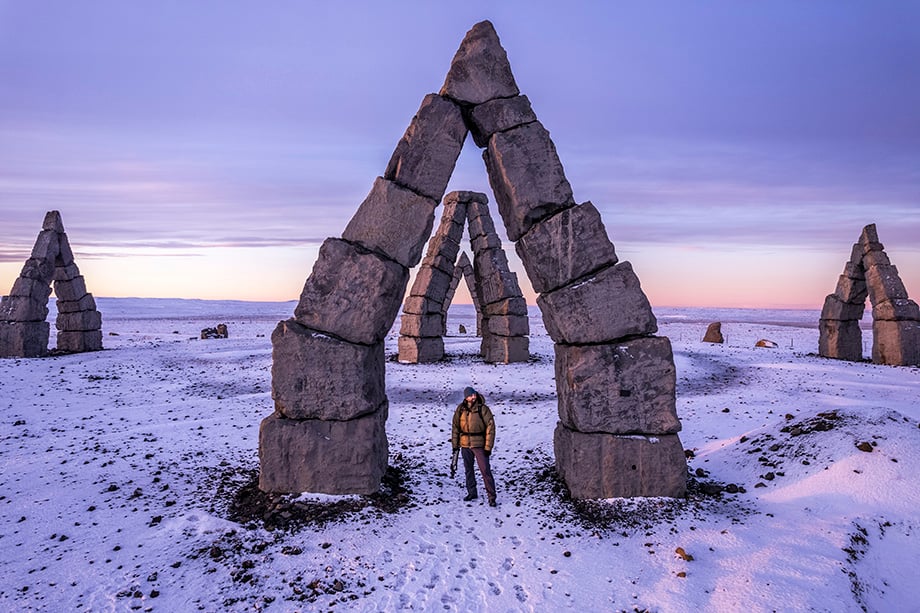 Photographer and director Rachid Dahnoun stands under the Arctic Henge stone structure in Iceland while shooting Lowepro content.