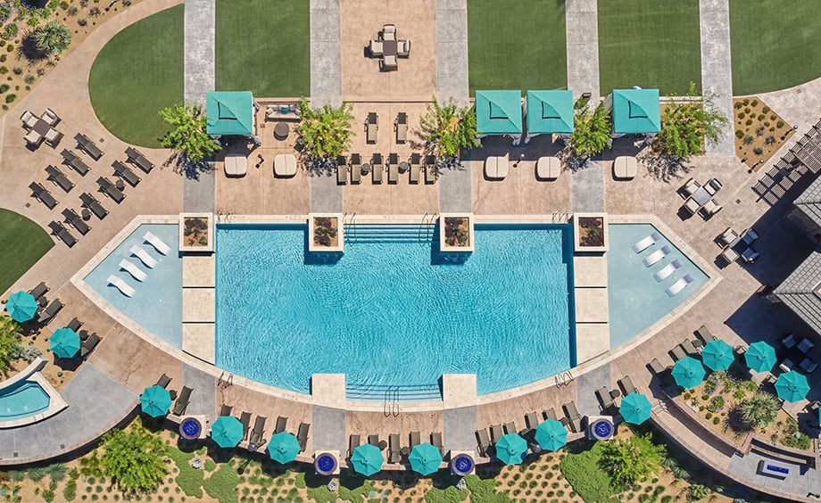 Birds-eye image of a hotel pool and surround lawn chairs taken with a drone by photographer Amy Mikler.