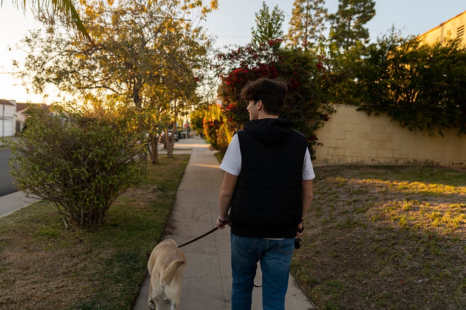 Joseph Olkha, 16, walking his dog near his home in Los Angeles, California.