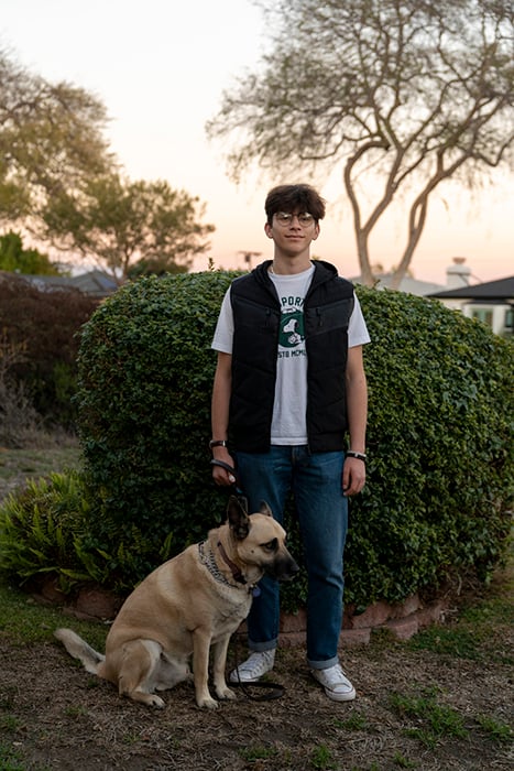 Joseph Olkha, 16, with his dog near his home in Los Angeles, California.