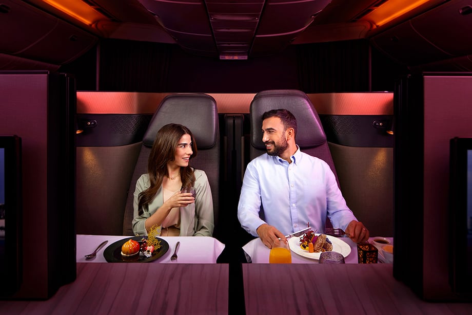 Couple dining in couples suite on Qatar flight shot by Antonio Cuellar.