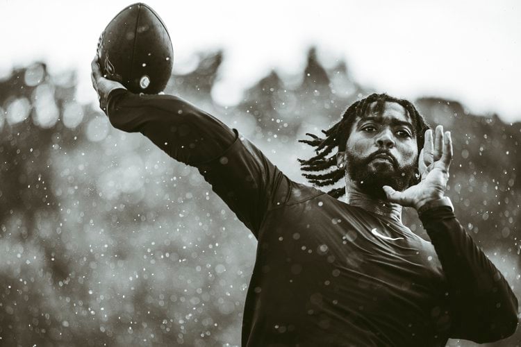 Footballer throwing ball by Chicago sports photographer Bryce France