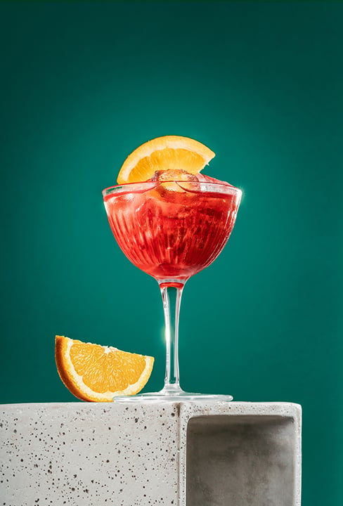 Refreshing cocktail with orange slice by London photographer Andrew Currie