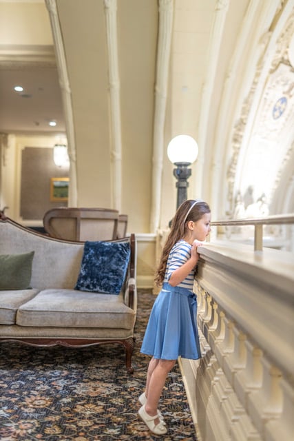 Photograph of a child in a hotel lobby.