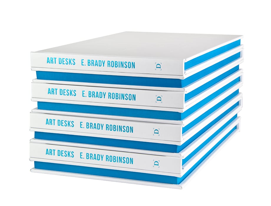 A stack of photobooks by E. Brady Robinson, published by Daylight Books.