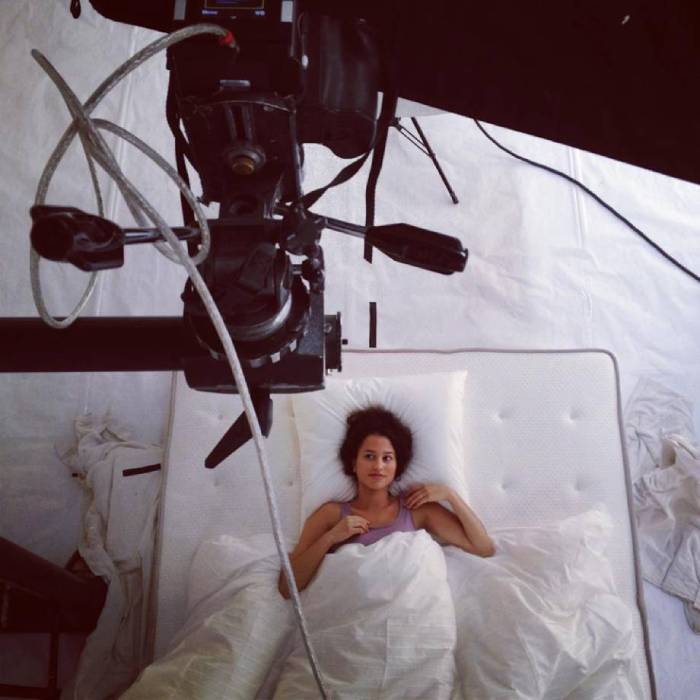 Behind the scenes shot, a model in bed, shot by Paris-based portrait photographer Antoine Doyen for Ikea