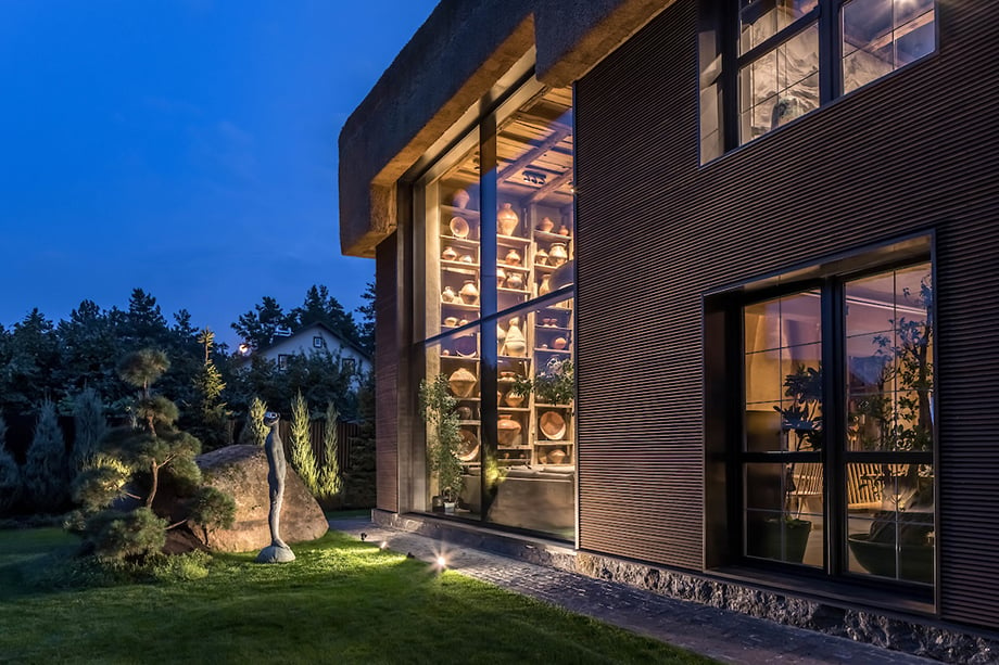 An image of the rear of the house at night, with Nazar Bilyk's sculpture "rain" under the moonlight
