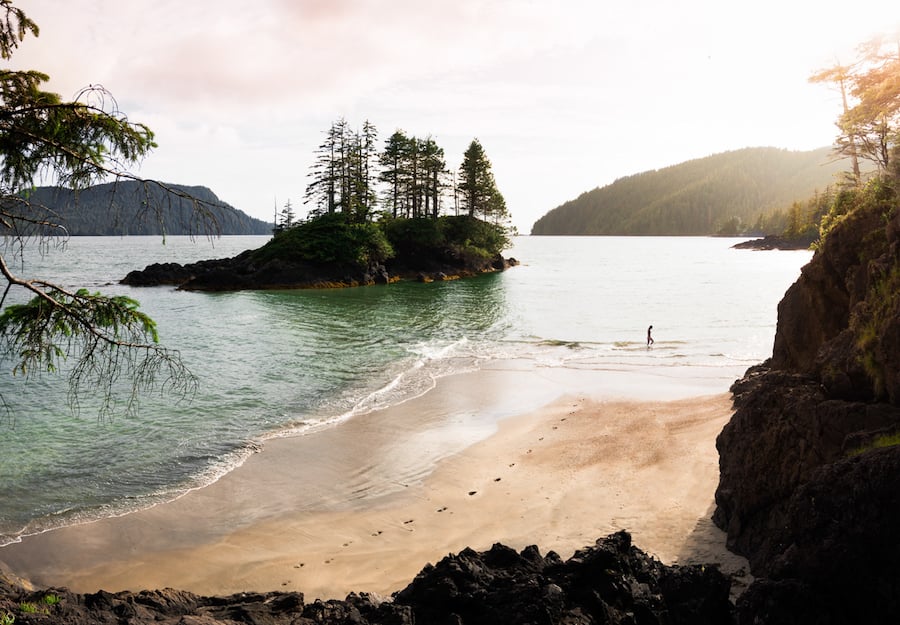 Beautiful panoramic view of a sandy beach with piney islands in the distance taken in San Josef Bay, Cape Scott Provincial Park, Northern Vancouver Island, BC, Canada by photographer christian Tisdale of Squamish, Canada.
