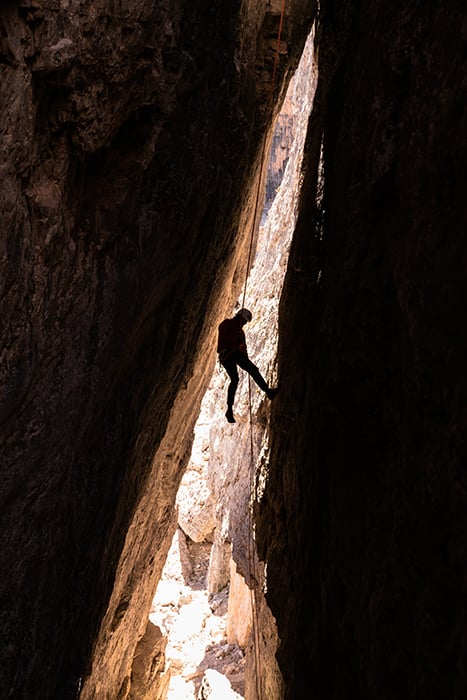 Pauli Trenkwalder rock climbing inside The Dolomites shot by Chandler Borries