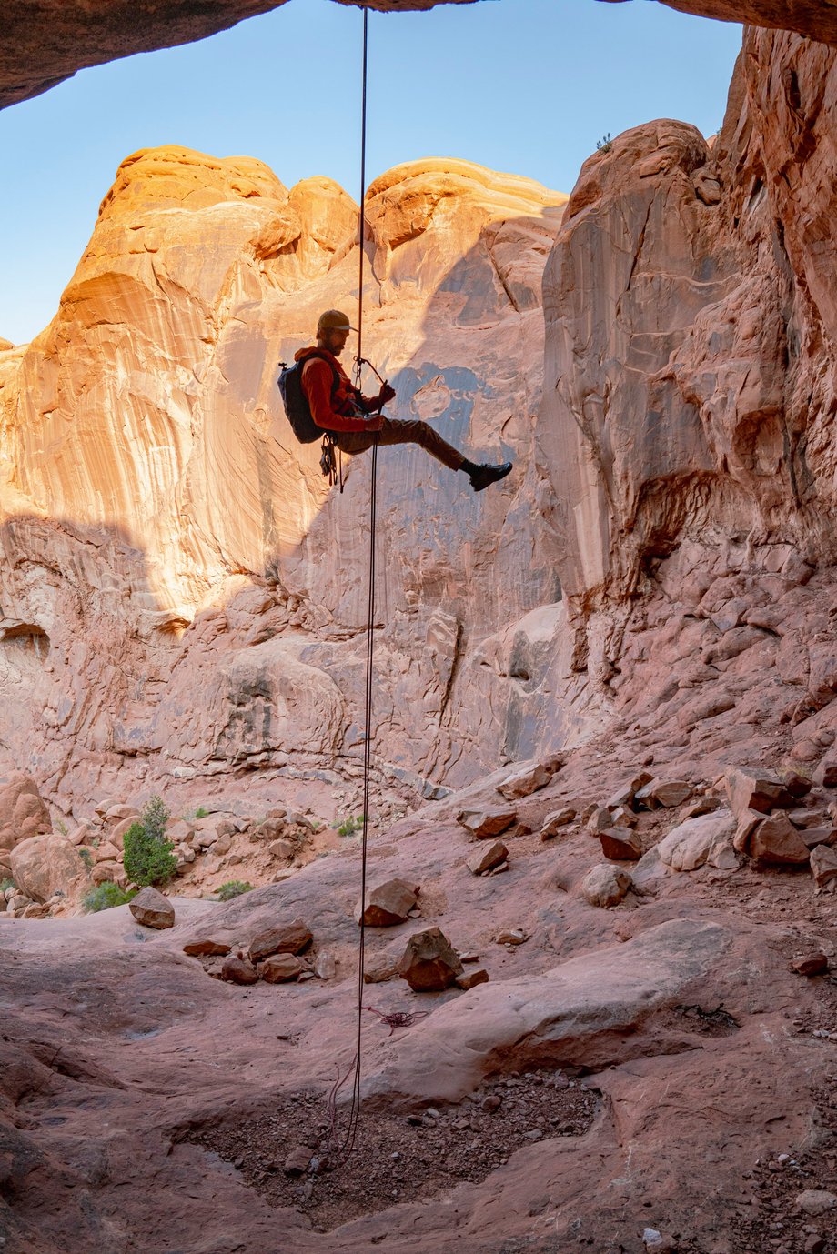 Dalton Johnson photographs male climber dangling from the rock in Moab for Coalatree and Gregory Packs